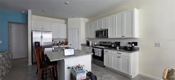 a kitchen with a sink stove and refrigerator