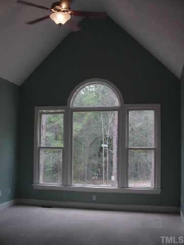 7224 Spring Meadow Lane Raleigh, NC 27606 - Photo 6 of 10 View of Master Bedroom. Notice vaulted ceiling and great view of large wooded rear yard. First floor location!