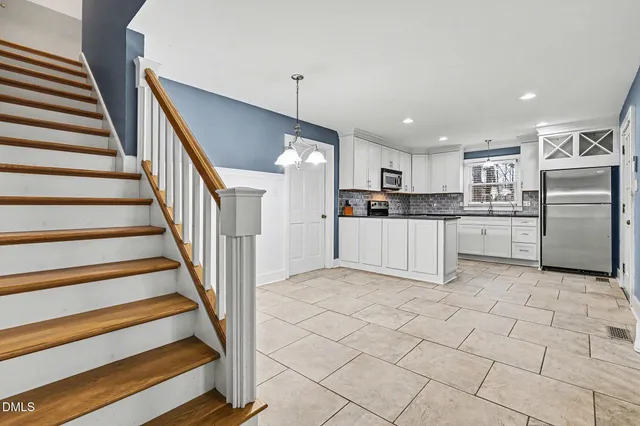 a view of kitchen with refrigerator and microwave
