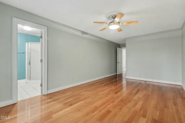 a bathroom with a granite countertop sink a mirror and a shower