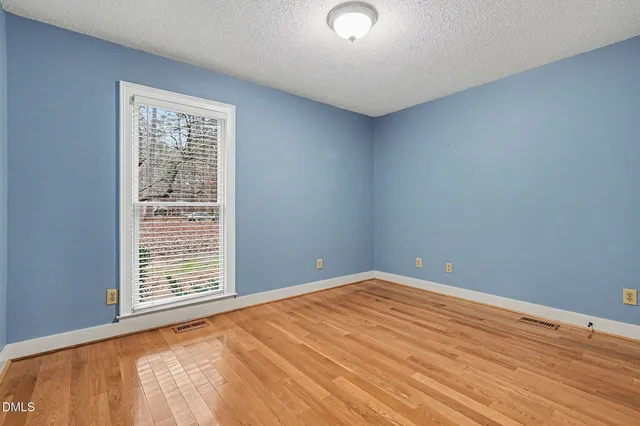 an empty room with windows and closet