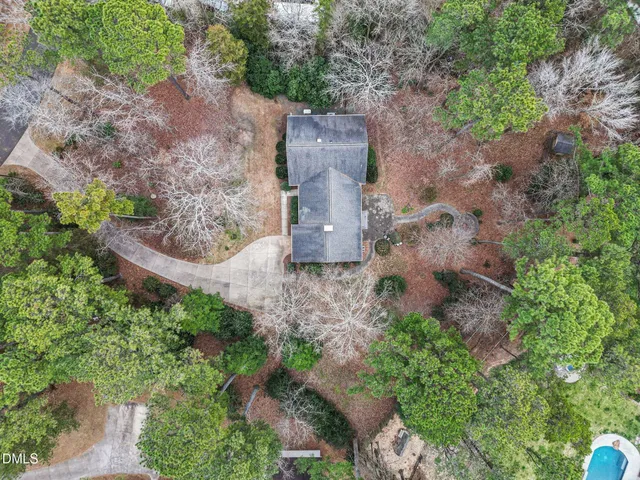 an aerial view of a house with a yard and a outdoor space