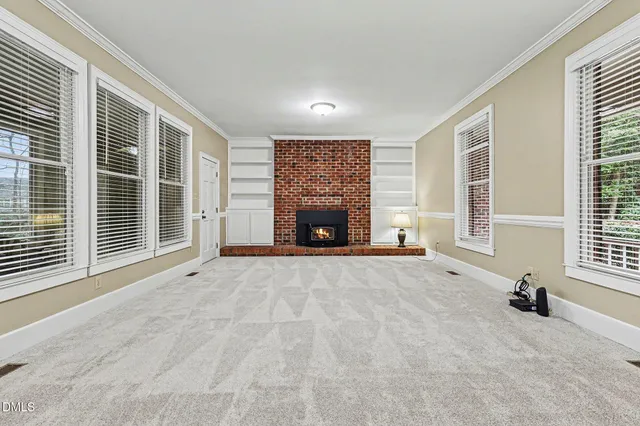 an empty room with furniture and a fireplace