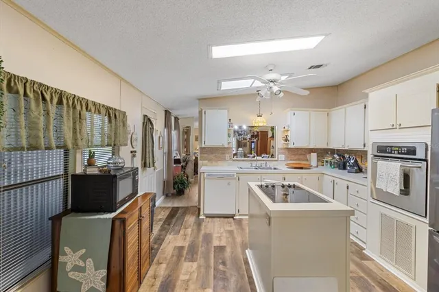 a kitchen with a sink stove and refrigerator