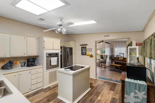 a kitchen with cabinets a sink and appliances