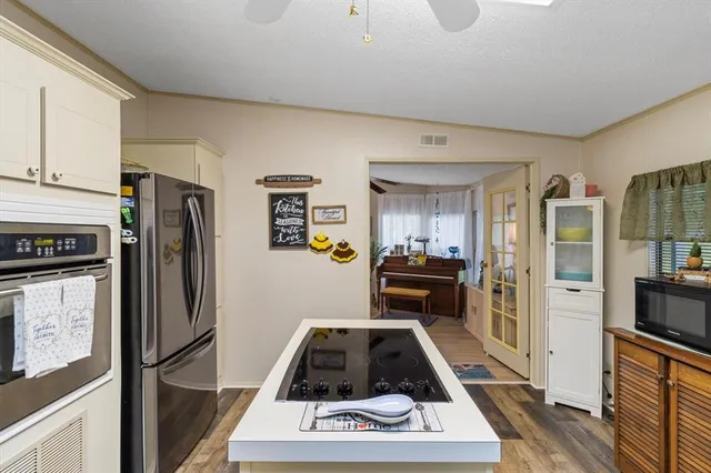 a kitchen with a refrigerator a stove and cabinets