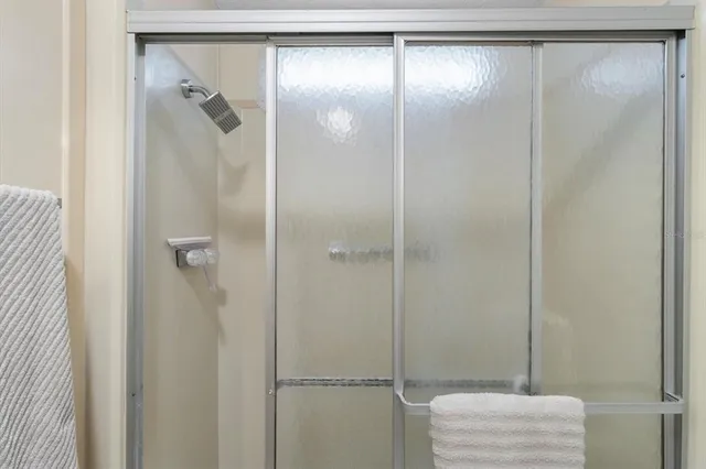 a bathroom with a glass shower door
