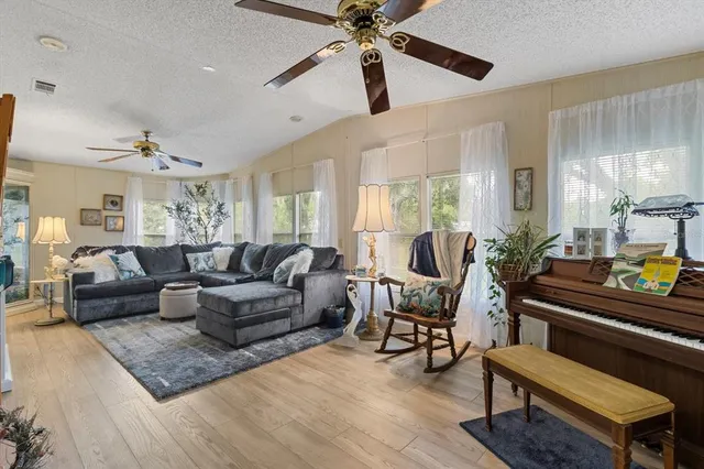 a living room with furniture and a piano