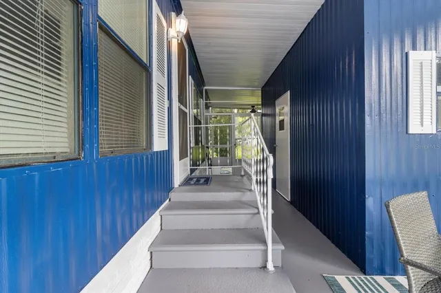 a view of entryway with wooden door and stairs