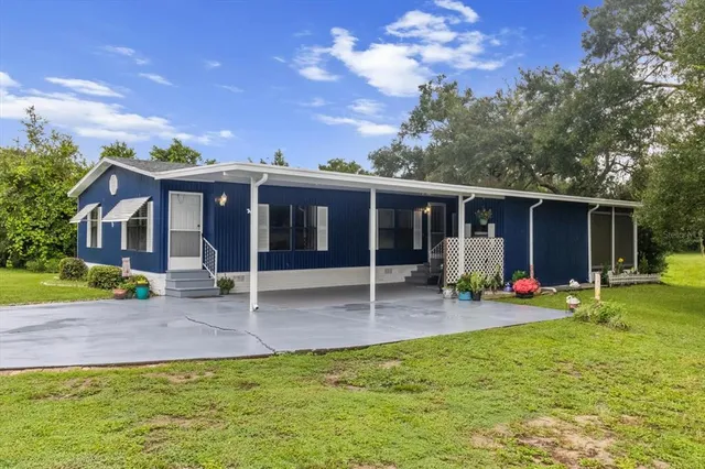 a view of a house with a backyard porch and sitting area