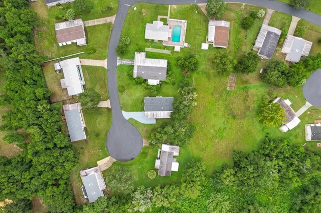 an aerial view of residential house with outdoor space and swimming pool