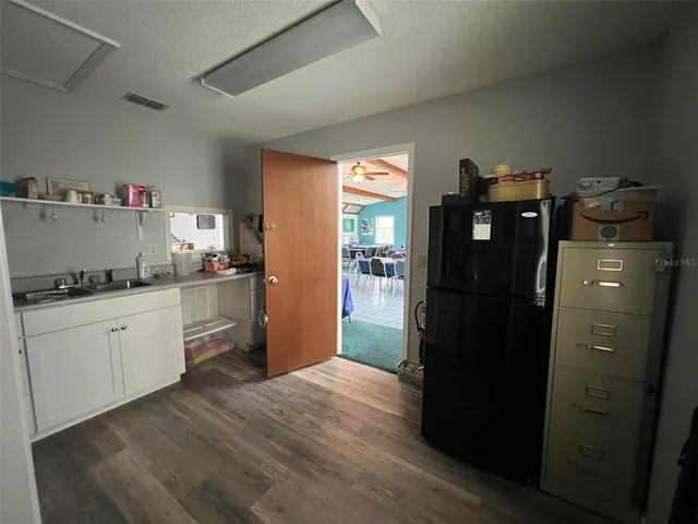 a kitchen with stainless steel appliances granite countertop a refrigerator and a stove