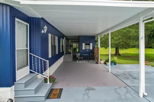a view of a porch with furniture and garden