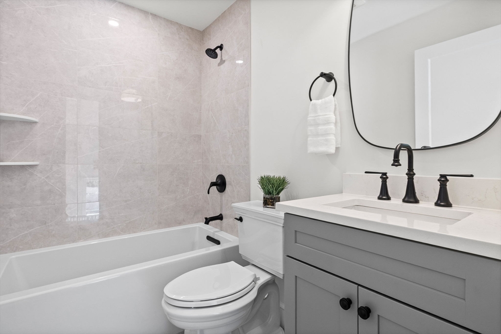 8 Common Court Lexington, MA 02421 - Photo 11 of 18 a bathroom with a sink a toilet and a mirror