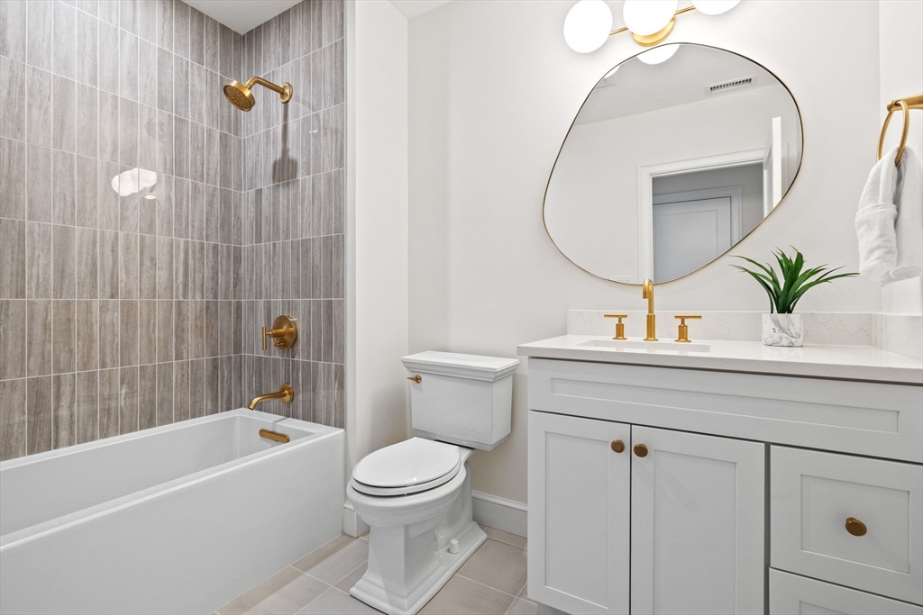8 Common Court Lexington, MA 02421 - Photo 14 of 18 a bathroom with a sink a mirror a toilet and bathtub