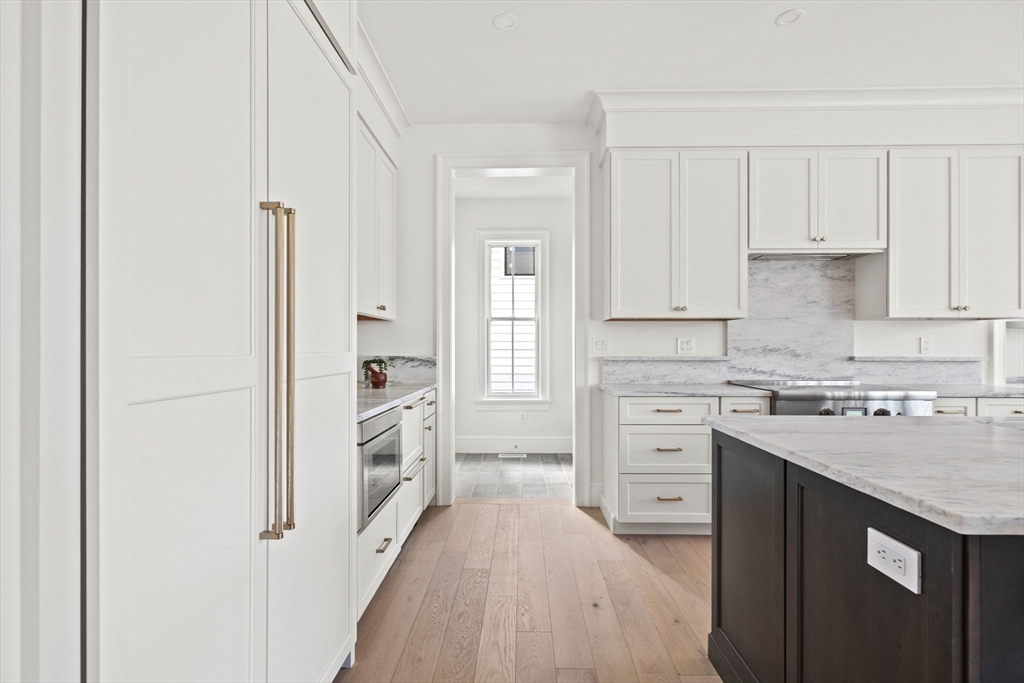 8 Common Court Lexington, MA 02421 - Photo 4 of 18 a kitchen with white cabinets and white appliances