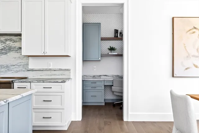 a kitchen with cabinets appliances and a wooden floor