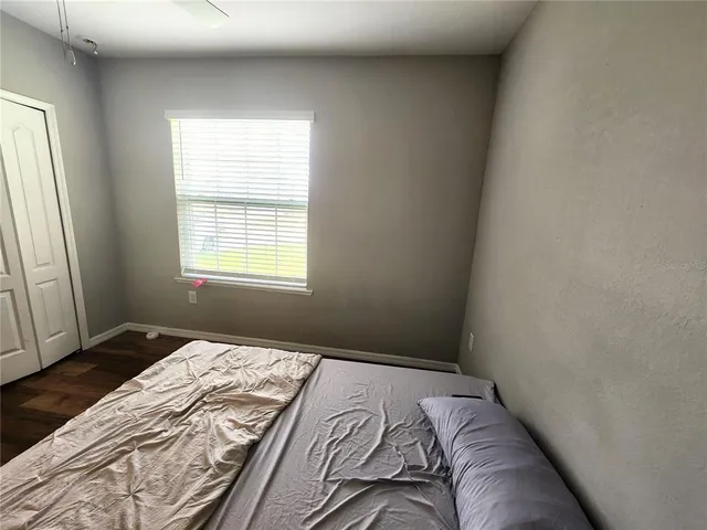 a bedroom with a bed and window