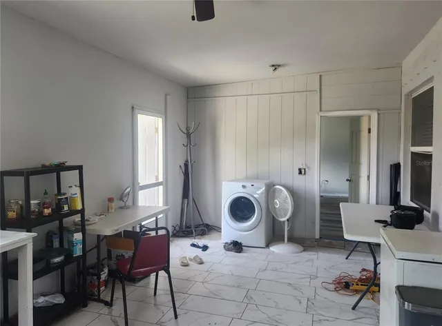 a backyard of a house with table and chairs