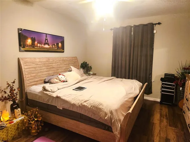 a bedroom with a bed and a painting on the wall