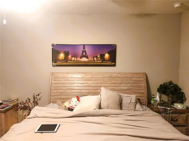 a bedroom with a bed and a dresser
