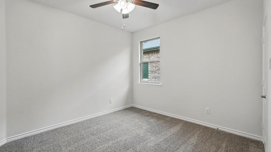 4162 Waldron Trail Forney, TX 75126 - Photo 21 of 29 Carpeted room with a ceiling fan, a window, and light-colored walls