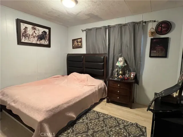 a bedroom with a bed and a painting on the wall