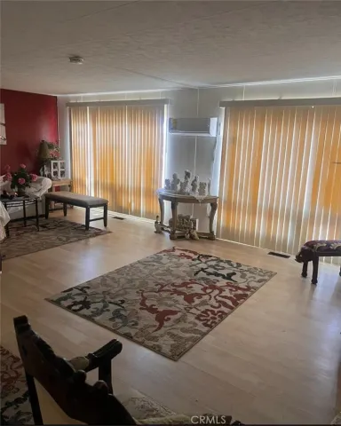 a living room with a rug table and a window