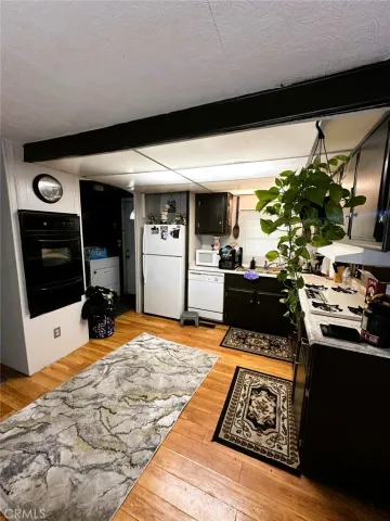 a kitchen with stainless steel appliances kitchen island granite countertop a sink stove and cabinets