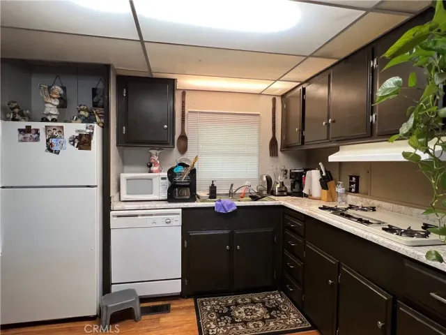 a kitchen with a sink appliances and cabinets