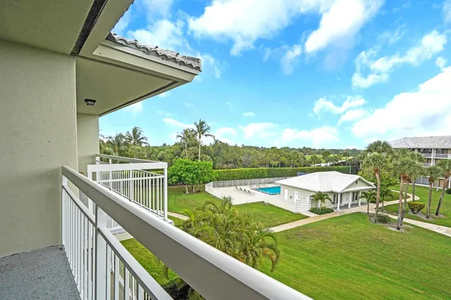 a view of a balcony with chairs and an ocean view