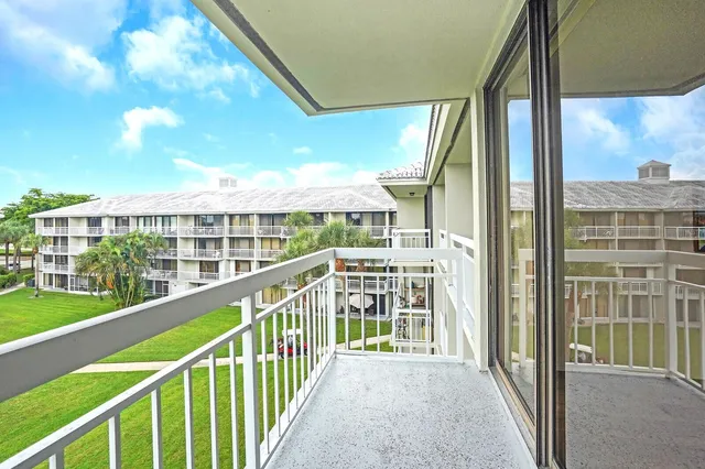 a view of balcony with a floor to ceiling window and wooden fence