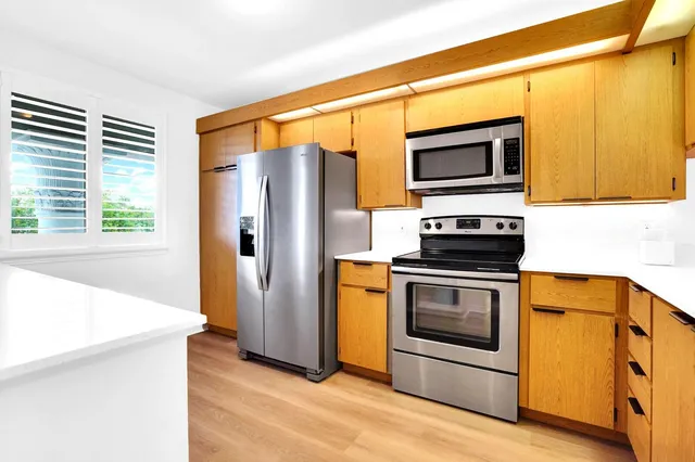 a kitchen with stainless steel appliances a stove microwave and a refrigerator