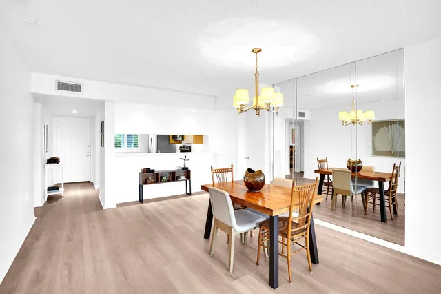 a view of a dining area with furniture and chandelier