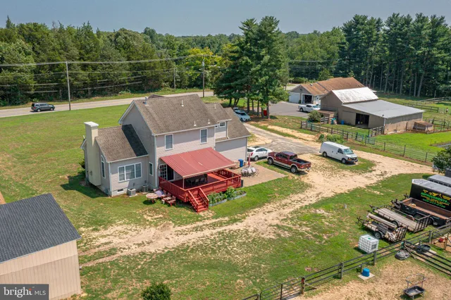 an aerial view of a house with pool a fire pit and outdoor seating