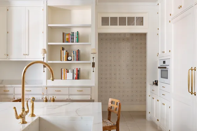 a kitchen with a table chairs sink and cabinets