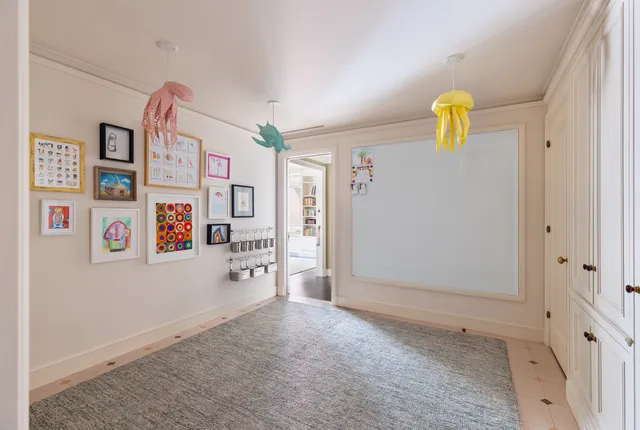 a spacious bedroom with a bed and a chandelier