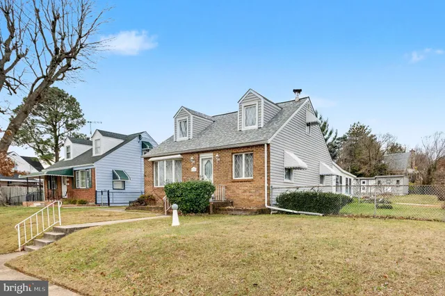 a view of a house with a yard and tree s