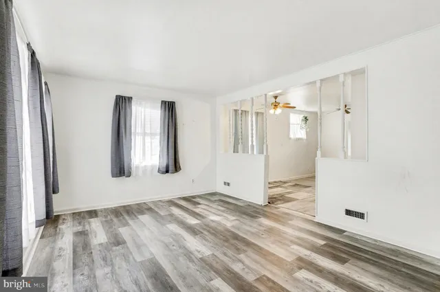 an empty room with windows and closet