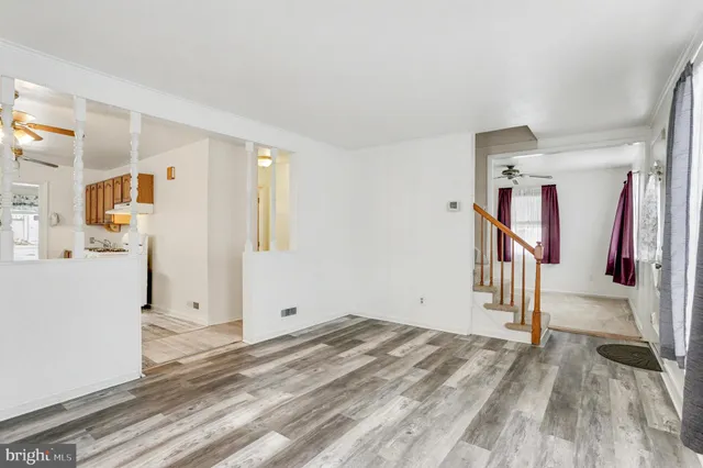 a view of a livingroom with wooden floor and white walls