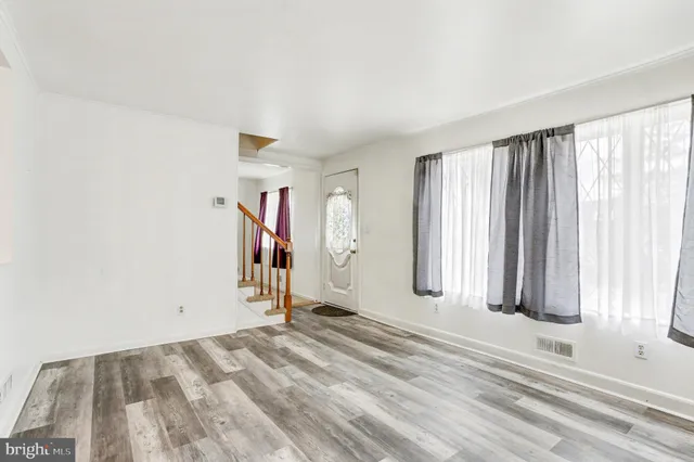 a view of a livingroom with wooden floor and a window