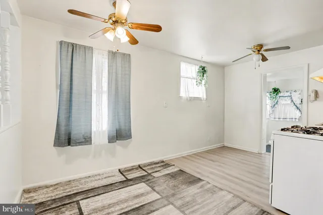 a bedroom with a bed and a chandelier fan