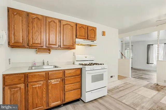 a kitchen with granite countertop cabinets stainless steel appliances and sink