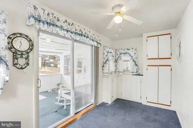 a view of a livingroom with a chandelier fan
