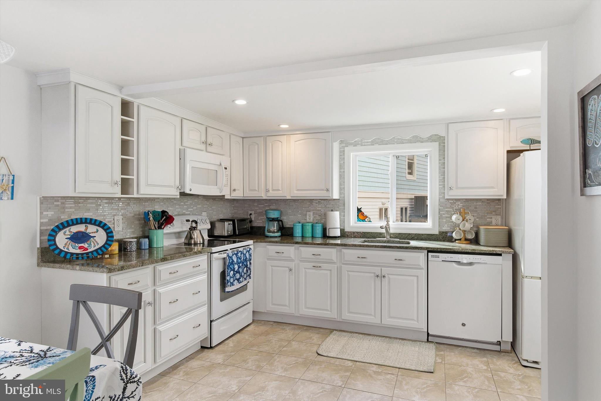 2 West Janet Road, Unit 1 Long Beach Township, NJ 08008 - Photo 11 of 36 a kitchen with stainless steel appliances granite countertop a sink and a refrigerator