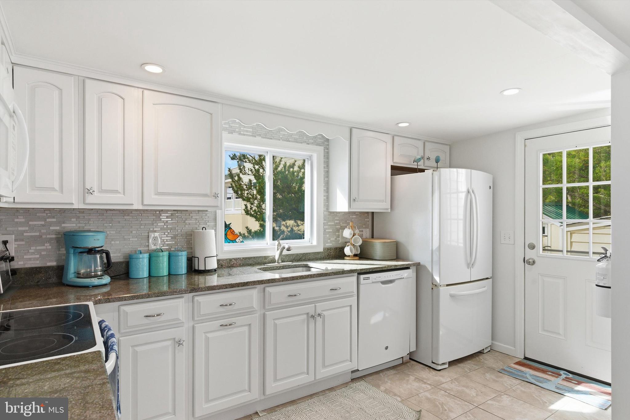 2 West Janet Road, Unit 1 Long Beach Township, NJ 08008 - Photo 12 of 36 a kitchen with white cabinets and white appliances