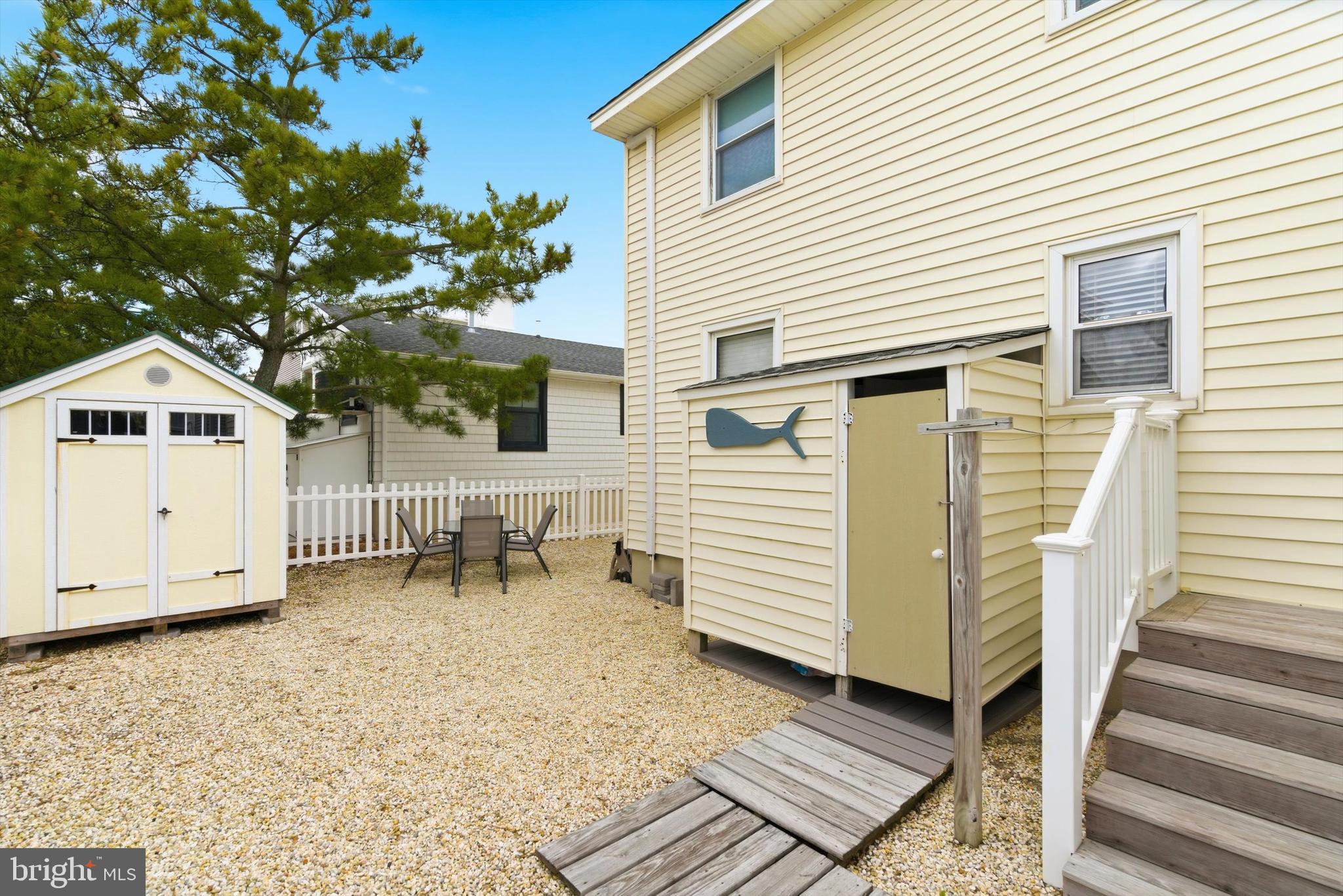 2 West Janet Road, Unit 1 Long Beach Township, NJ 08008 - Photo 24 of 36 a backyard of a house with table and chairs