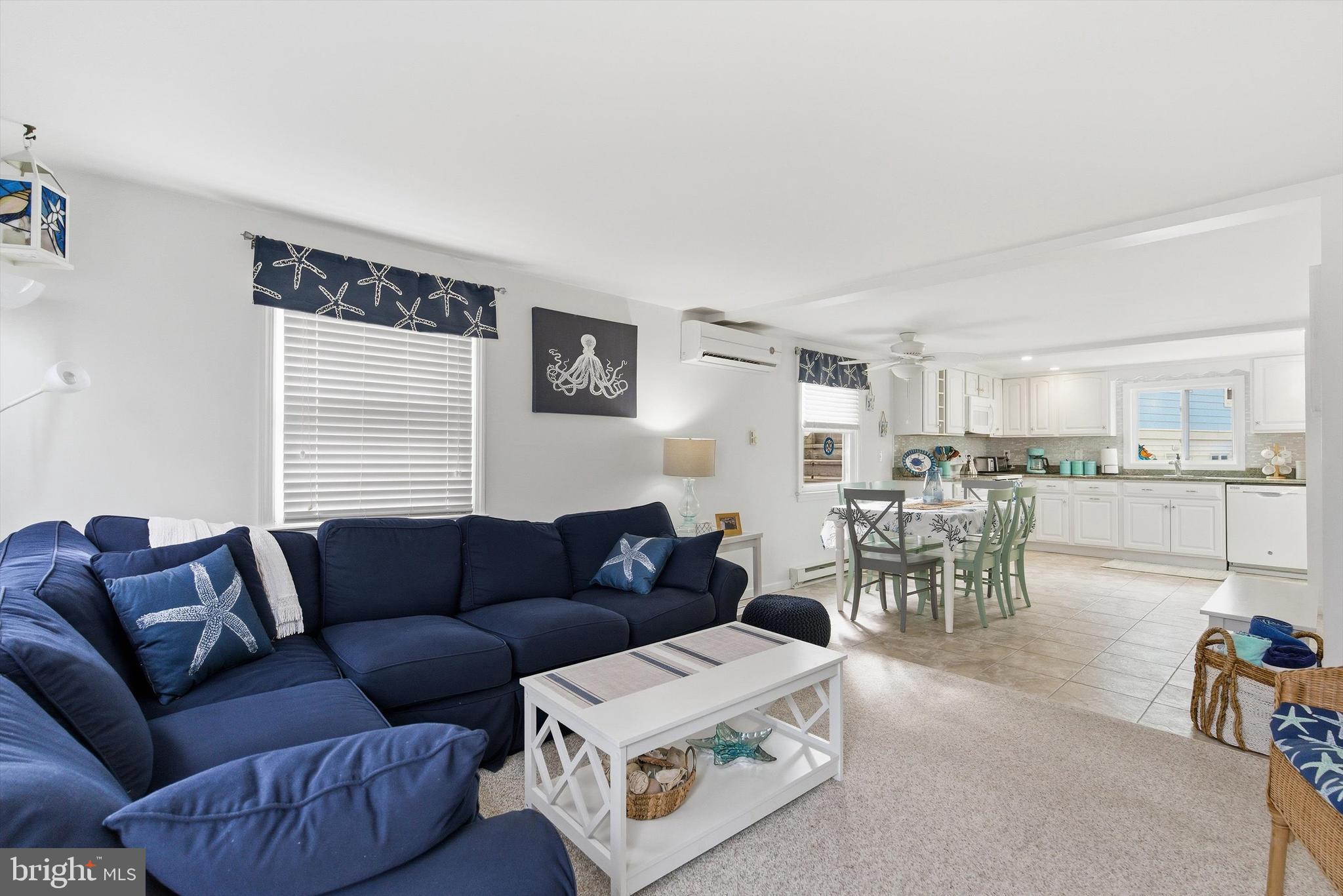 2 West Janet Road, Unit 1 Long Beach Township, NJ 08008 - Photo 8 of 36 a living room with furniture and a large window