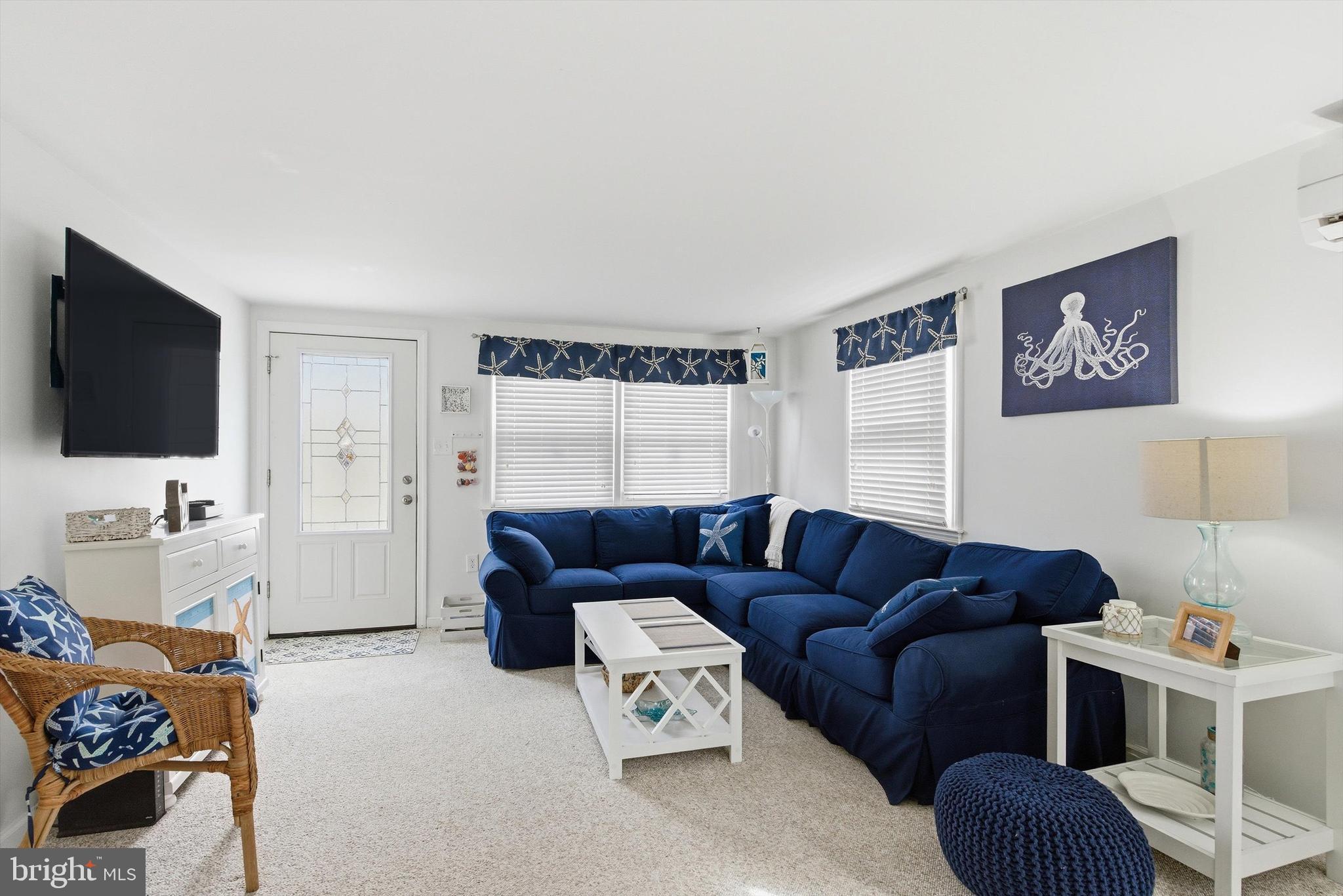 2 West Janet Road, Unit 1 Long Beach Township, NJ 08008 - Photo 9 of 36 a living room with furniture and a flat screen tv