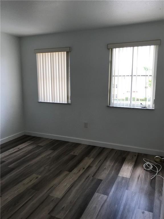 4331 Southwest 160th Avenue, Unit 200 Miramar, FL 33027 - Photo 12 of 19 an empty room with wooden floor and windows